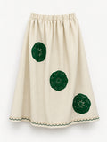 Cream skirt with green crocheted motifs and a delicate lace-trimmed hem