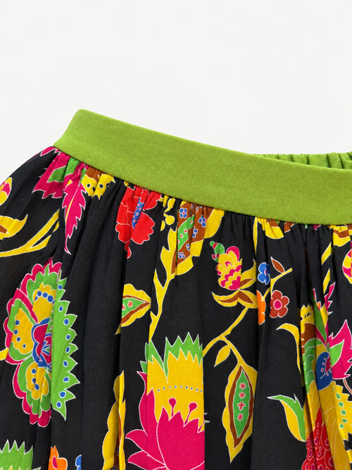 Black floral skirt with colourful flowers, a lime-green waistband and a wide lime-green hem