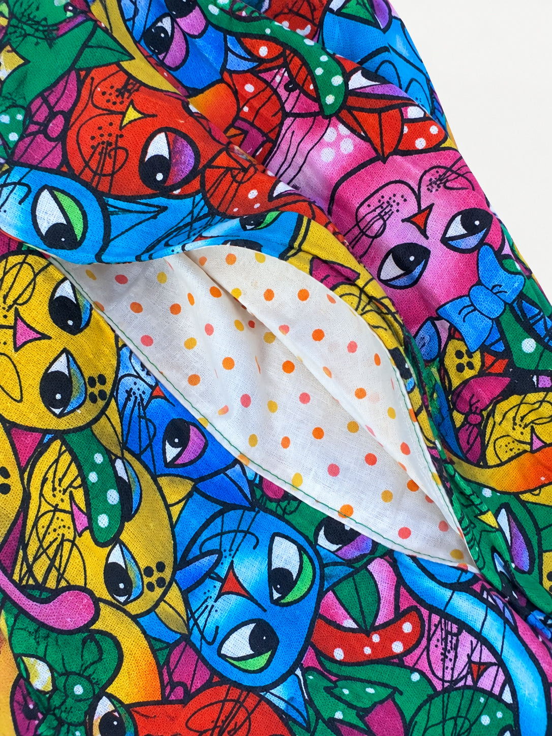 Colourful cat-print skirt with a turquoise waistband and wide turquoise hem