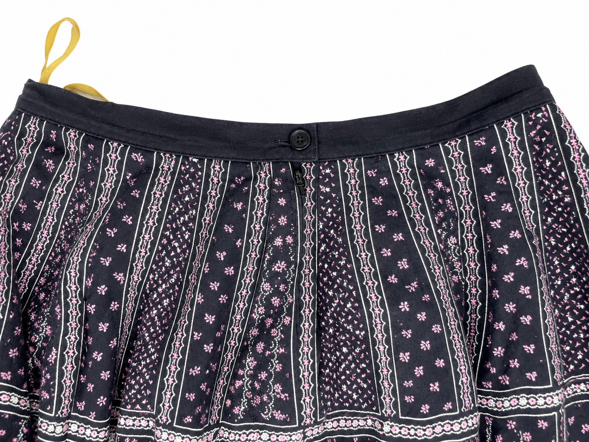 Cotton skirt waistband, button and zip detail on white background