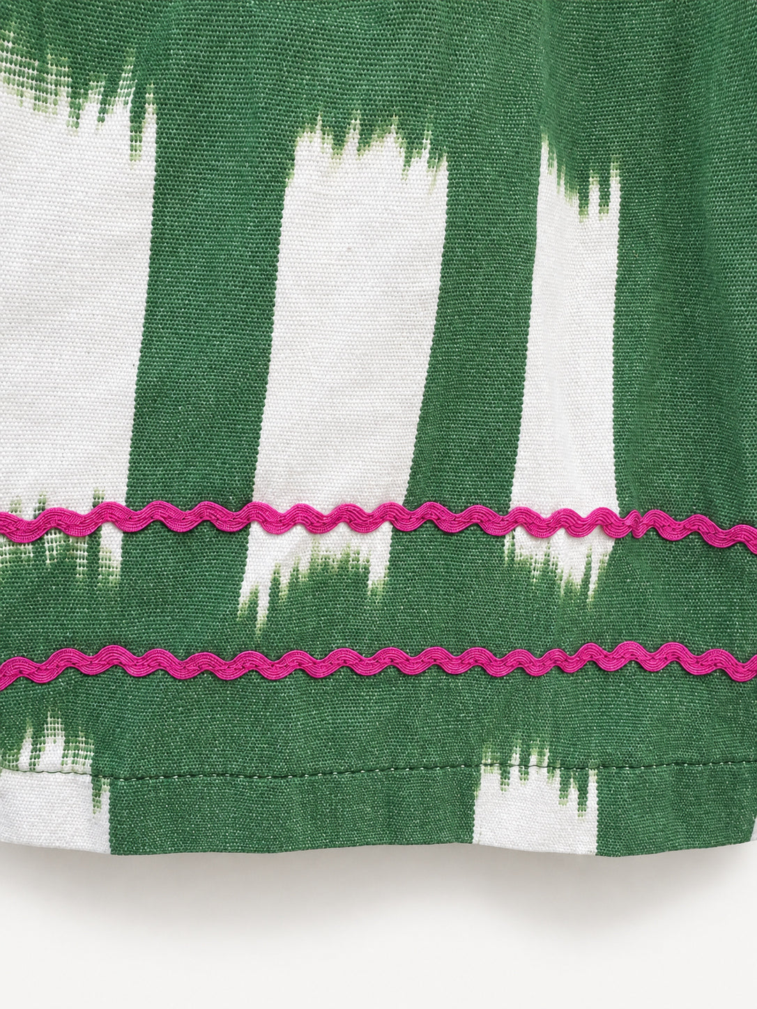Green checked skirt with a green-and-cream ikat panel and pink rickrack trim