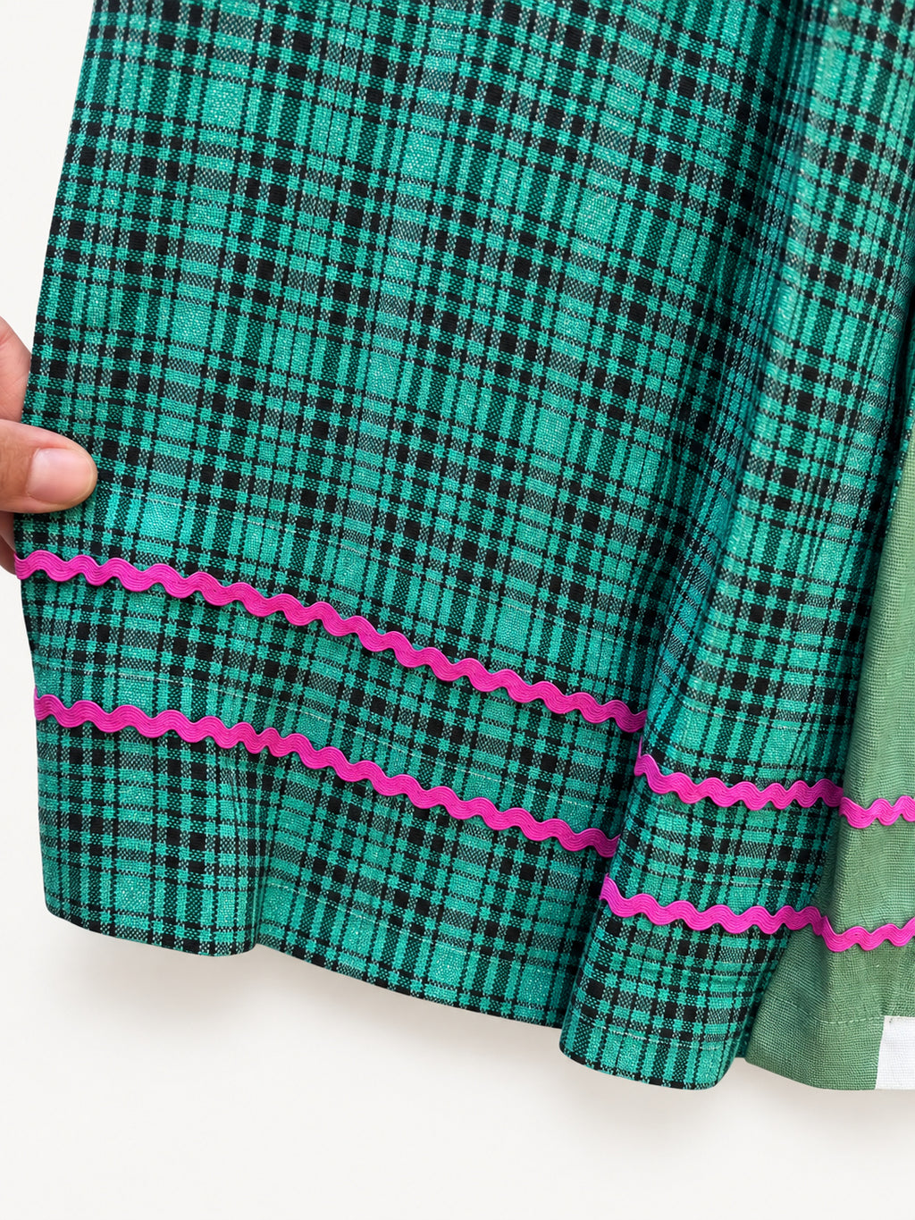 Green checked skirt with a green-and-cream ikat panel and pink rickrack trim