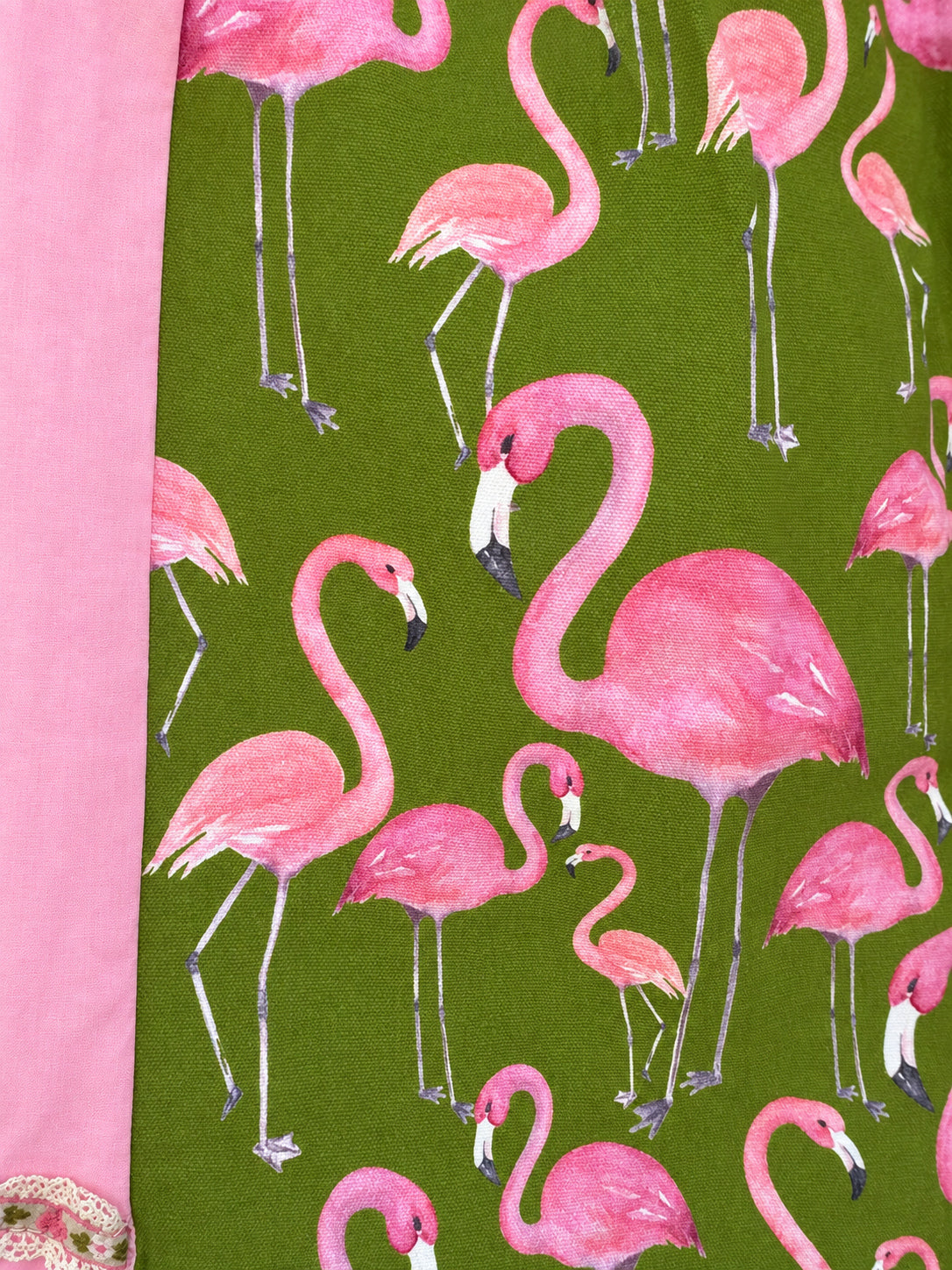 Pink skirt with an olive-green flamingo-print panel and decorative ribbon trim