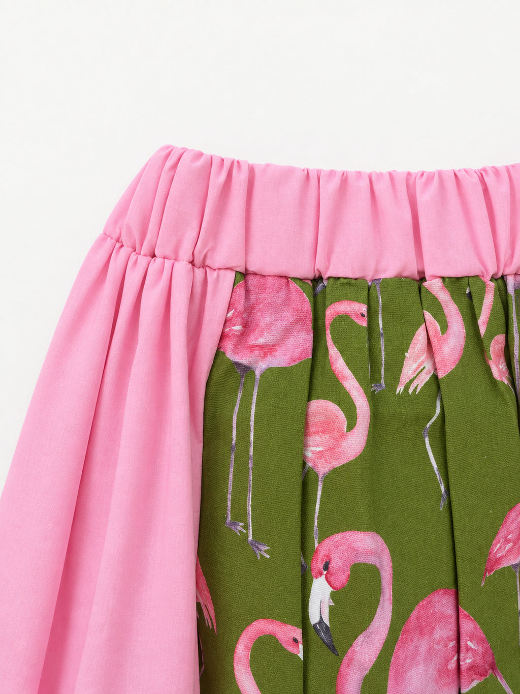 Pink skirt with an olive-green flamingo-print panel and decorative ribbon trim