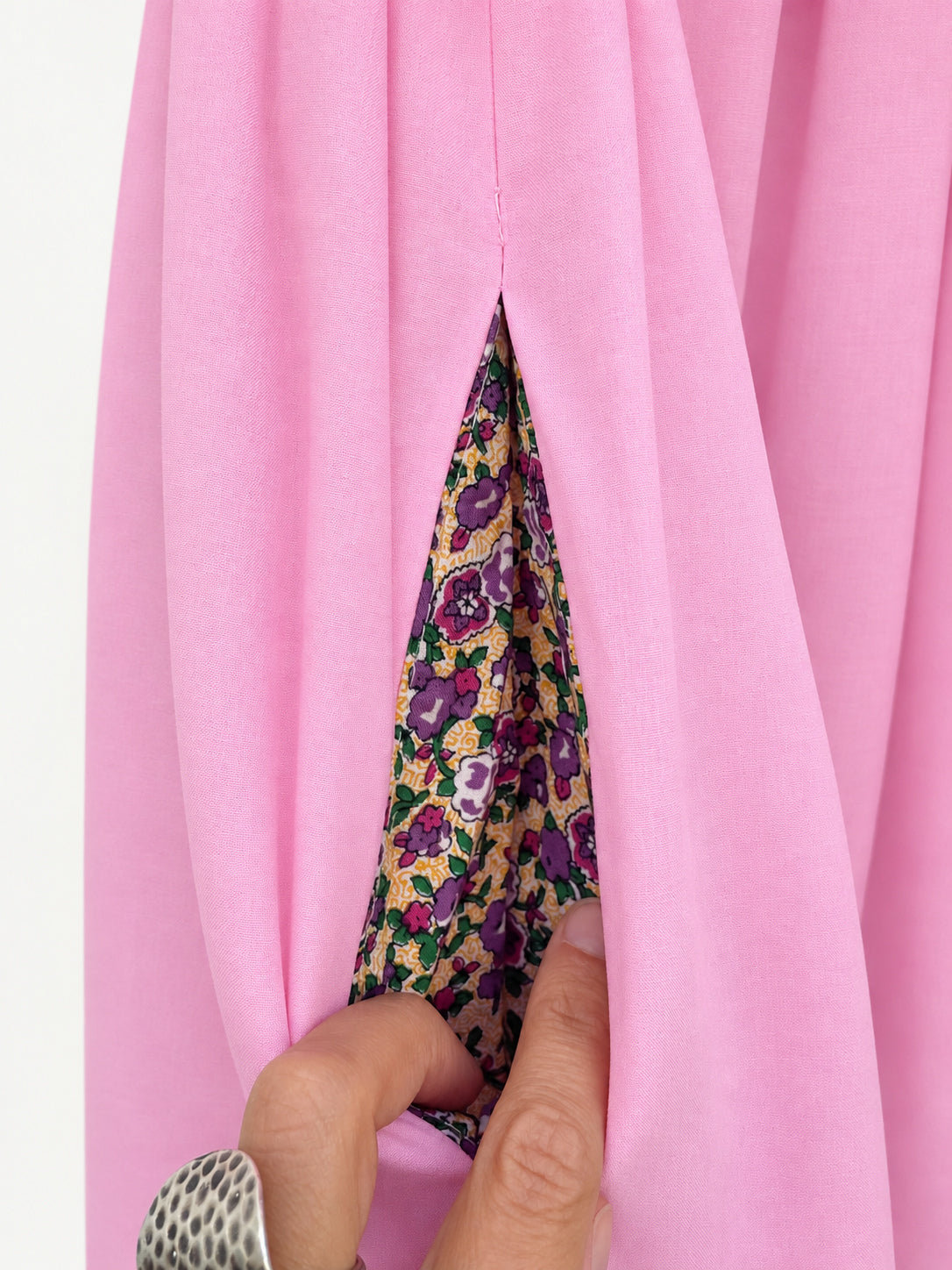 Pink skirt with an olive-green flamingo-print panel and decorative ribbon trim