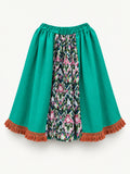 Bright green skirt with a multicoloured centre panel and orange tassel trim