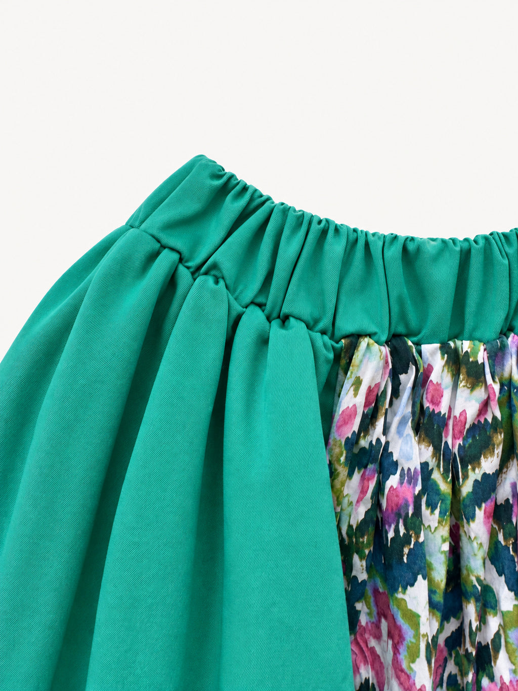 Bright green skirt with a multicoloured centre panel and orange tassel trim