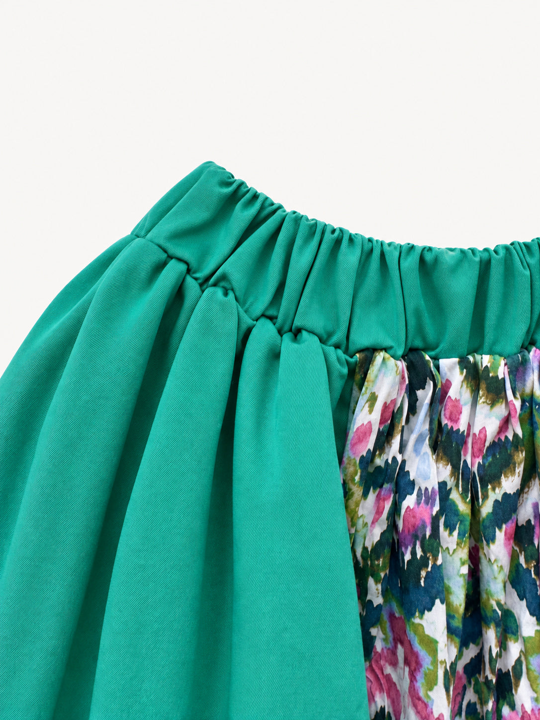 Bright green skirt with a multicoloured centre panel and orange tassel trim