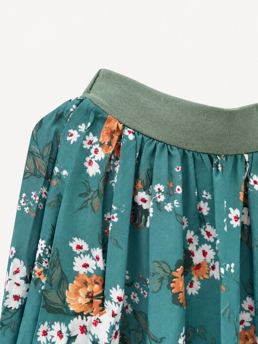 Detail of sage-green waistband and floral fabric