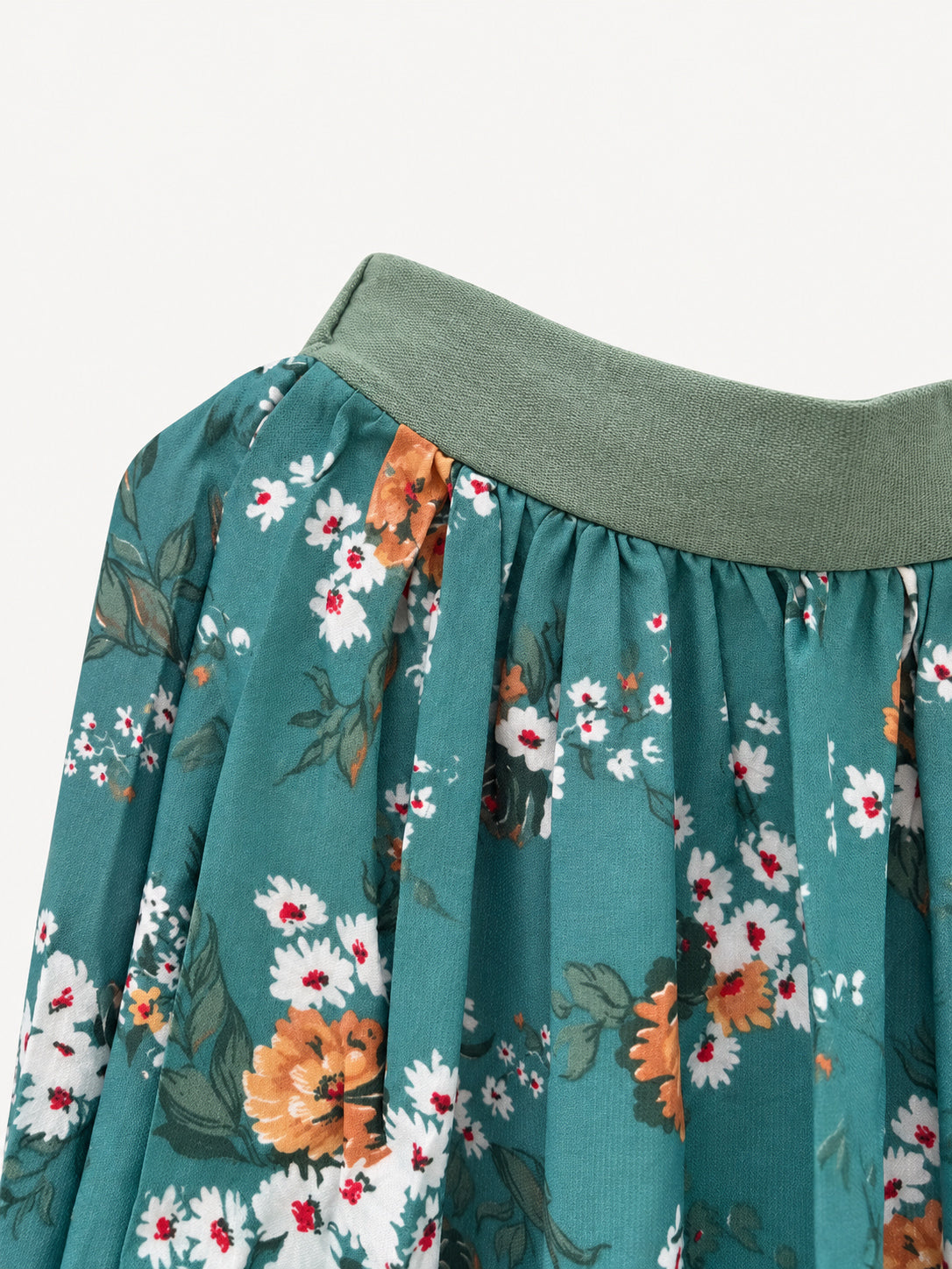 Detail of sage-green waistband and floral fabric