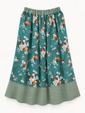 Full view of turquoise floral summer skirt with sage-green linen waistband and wide hem