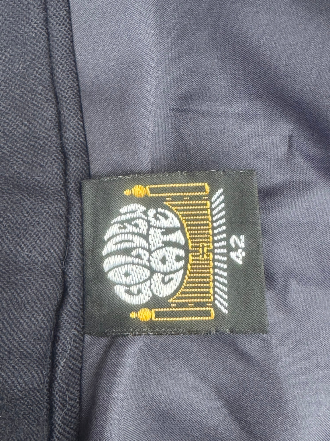 Original garment label showing size 42