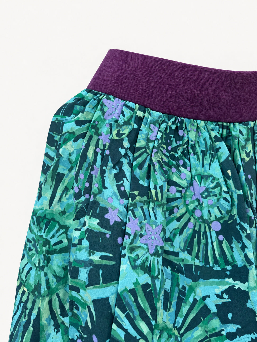 Teal patterned skirt with a purple waistband and wide purple hem