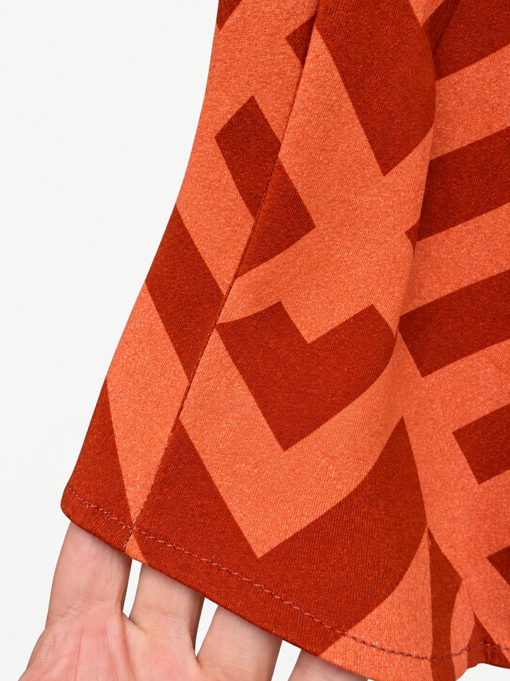 Orange geometric-print skirt with a navy-blue elastic waistband