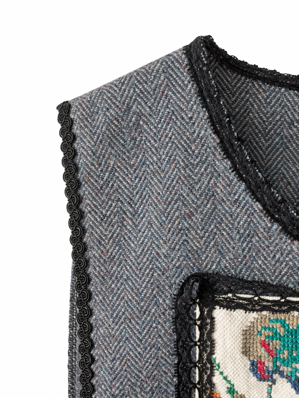 Parrot’s Garden grey herringbone vest — shoulder view with black lace and colourful bird embroidery