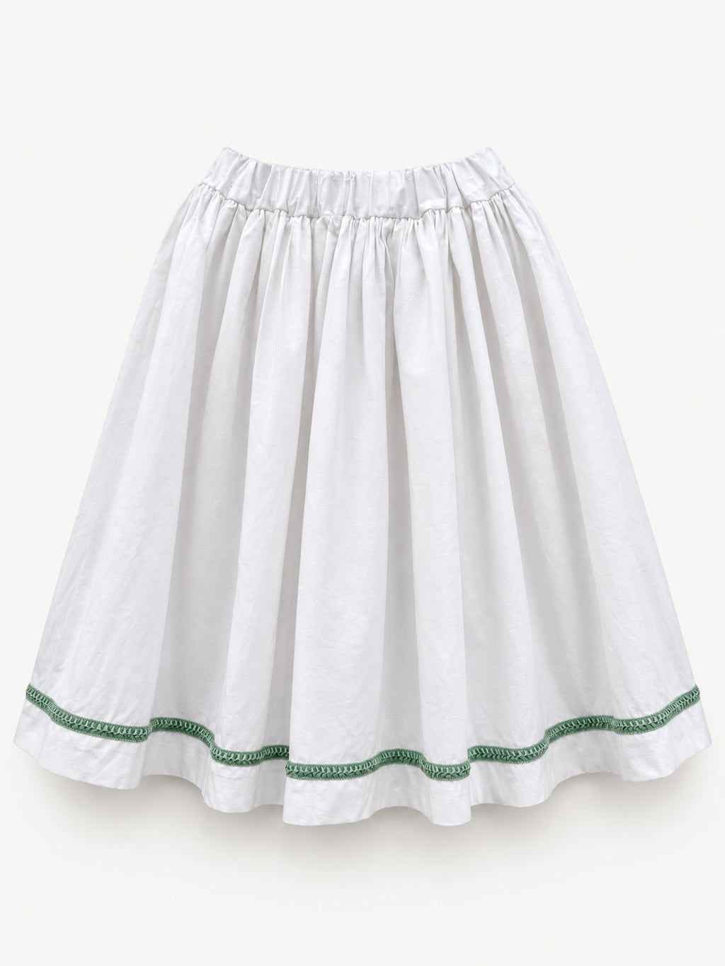 White gathered skirt with green decorative trim near the hem
