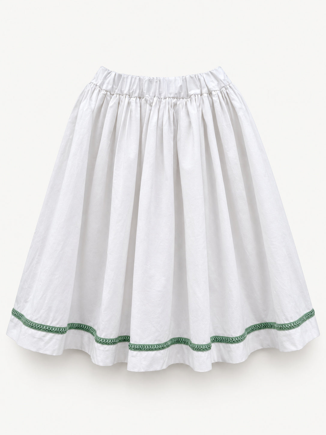 White gathered skirt with green decorative trim near the hem