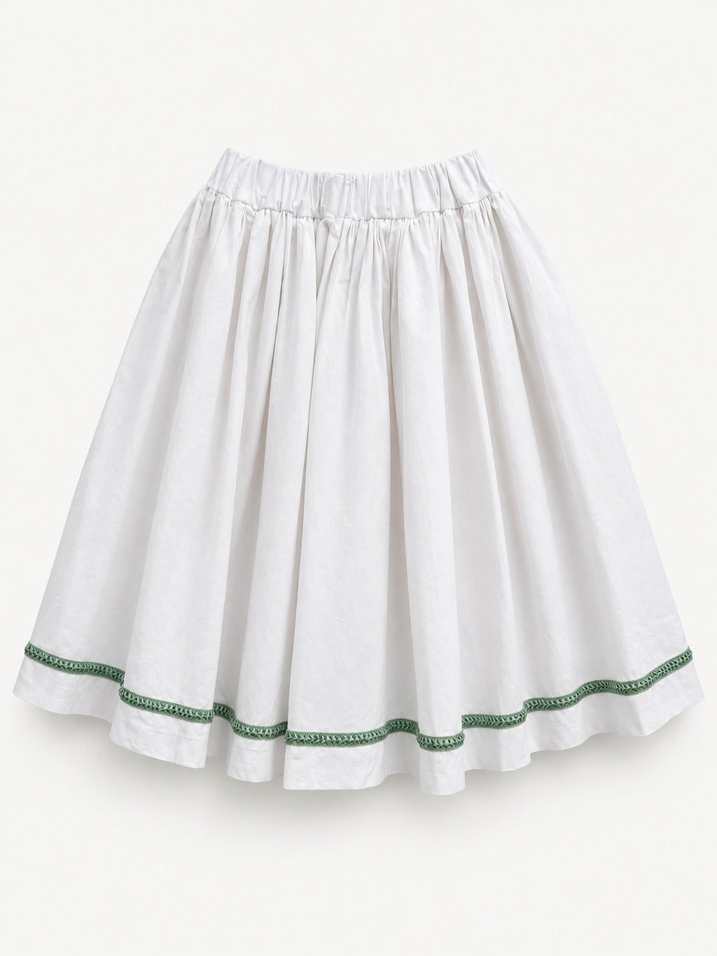 White gathered skirt with green decorative trim near the hem