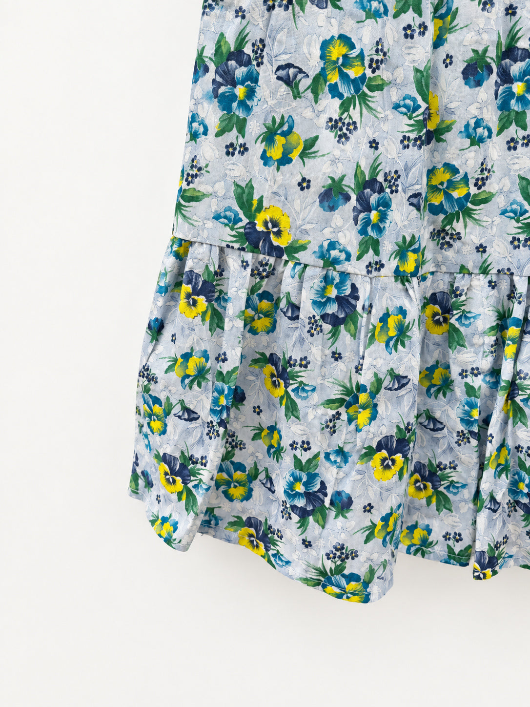 Pale-blue floral summer skirt with yellow and blue pansies, green elastic waistband and gathered lower tier