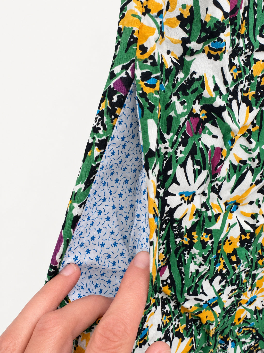 Long floral skirt with white and yellow flowers, a gathered lower tier and red-green zigzag elastic waistband