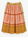 Full view of orange floral tablecloth skirt with mustard-yellow borders