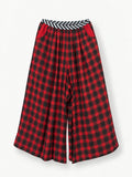 The Rebel Trousers — wide red-and-black checked legs, striped waistband and red pockets