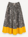Black-and-cream leopard-print skirt with a wide yellow hem