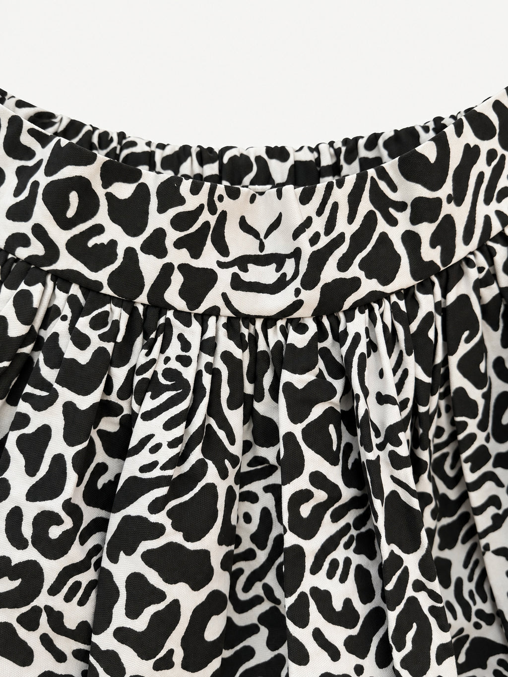 Black-and-cream leopard-print skirt with a wide yellow hem