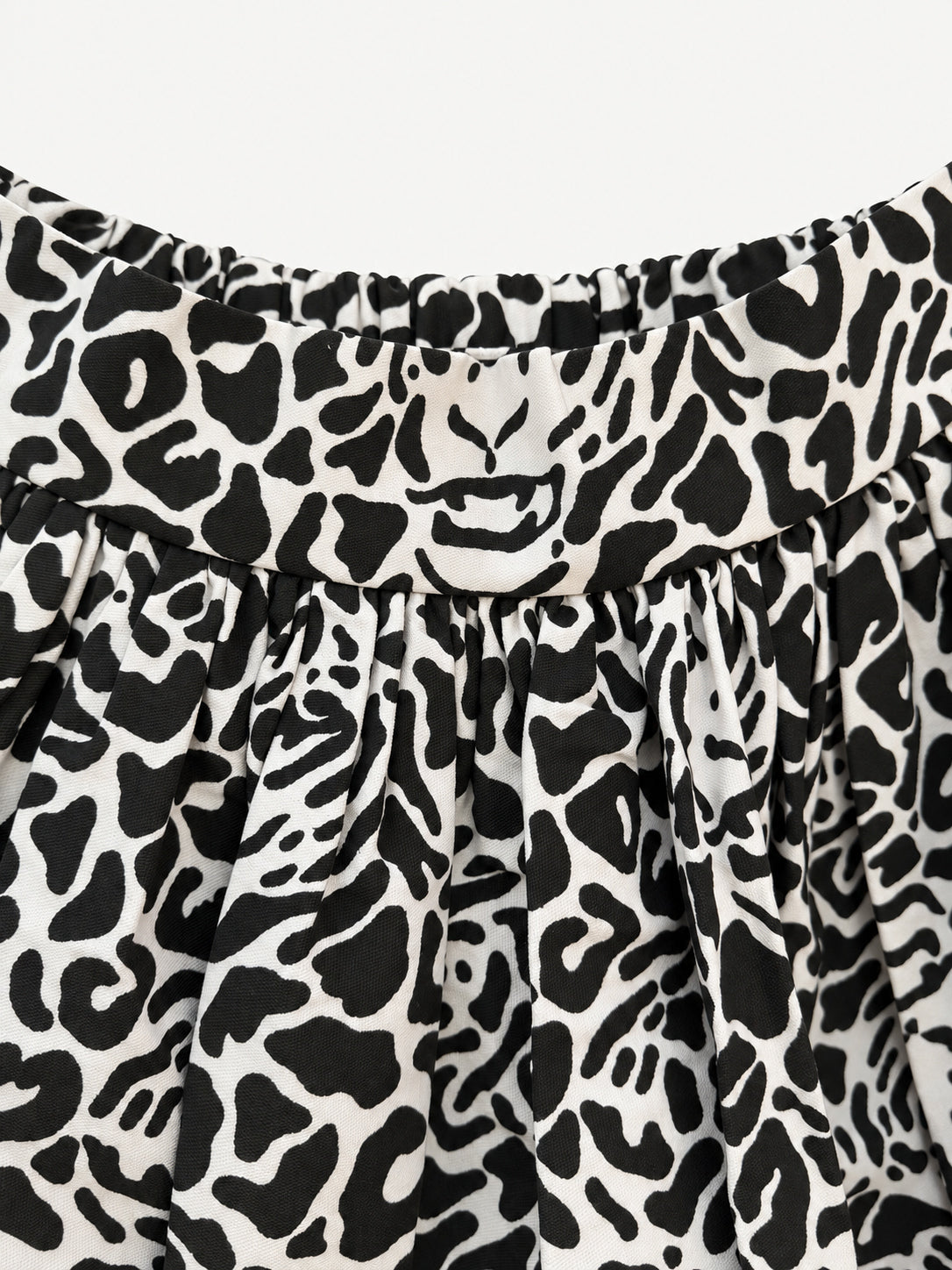 Black-and-cream leopard-print skirt with a wide yellow hem