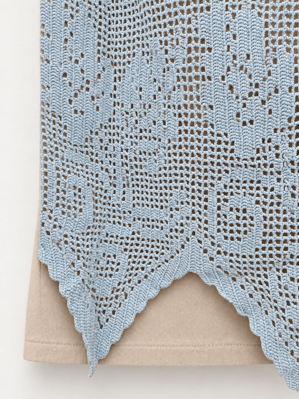 Detail of pale-blue hand-crocheted curtain panel