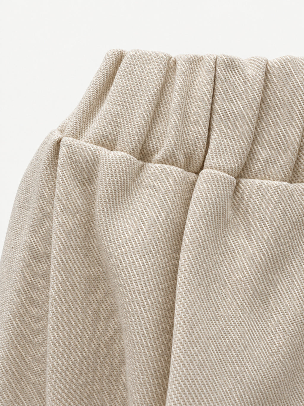 Detail of elasticated waistband and thick cream fabric